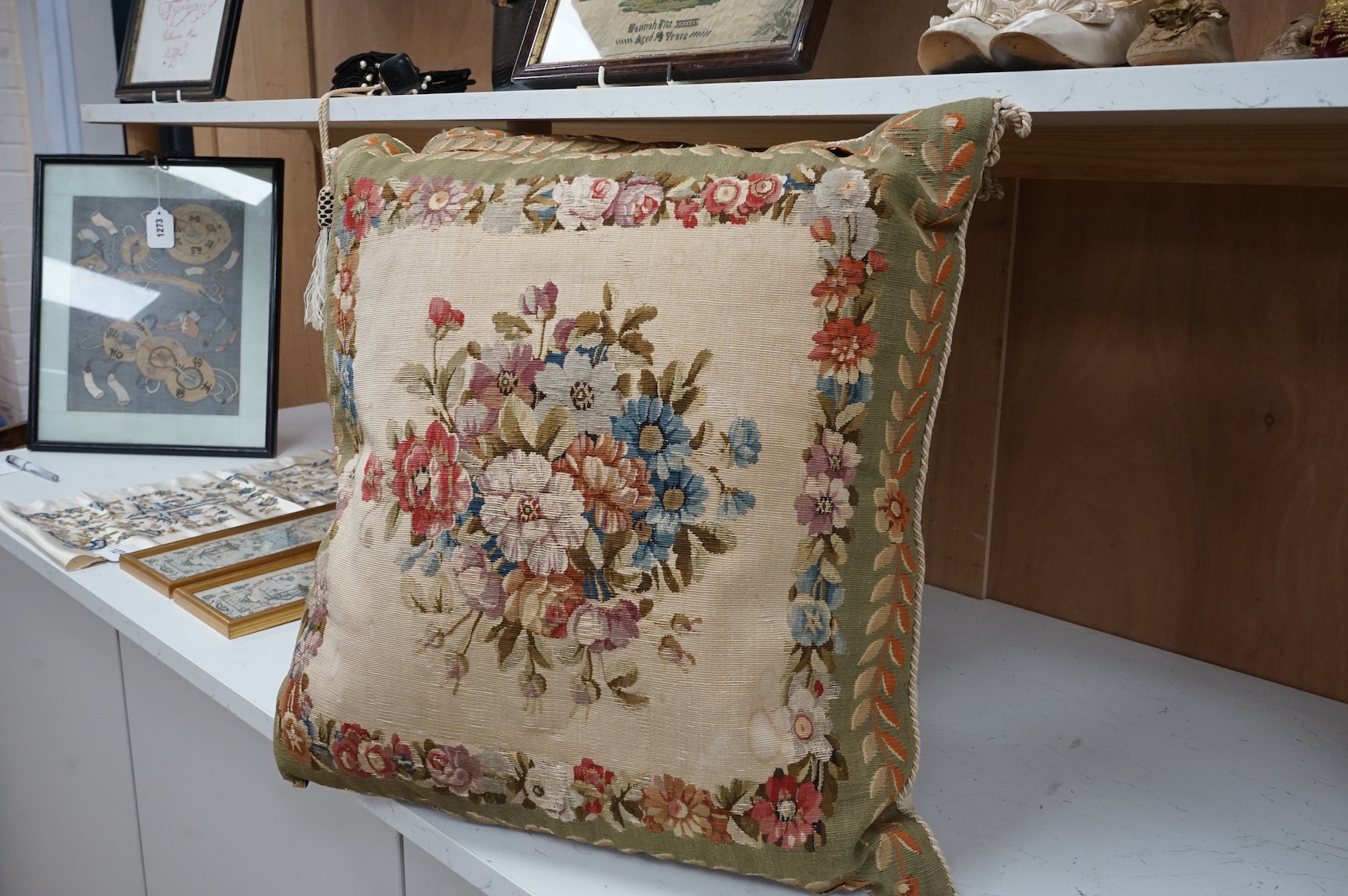 A large pair of 20th century Aubusson floral tapestry cushions. Woven with a central cartouche of roses and garden flowers within a floral border, green band of stylistic leaf design. Finished with cording and backed wit